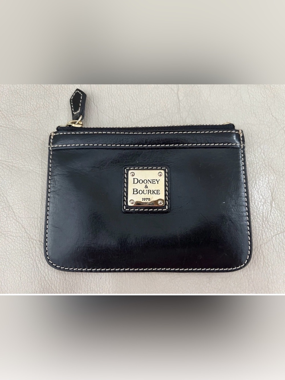 Dooney & Bourke Black Leather Zip Wristlet with White Stitching and Gold Plaque